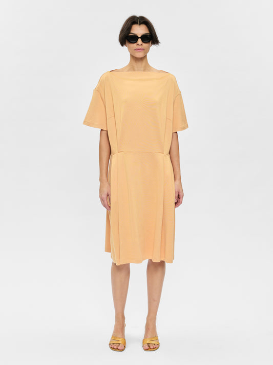 Woman wearing a yellow dress on a white background