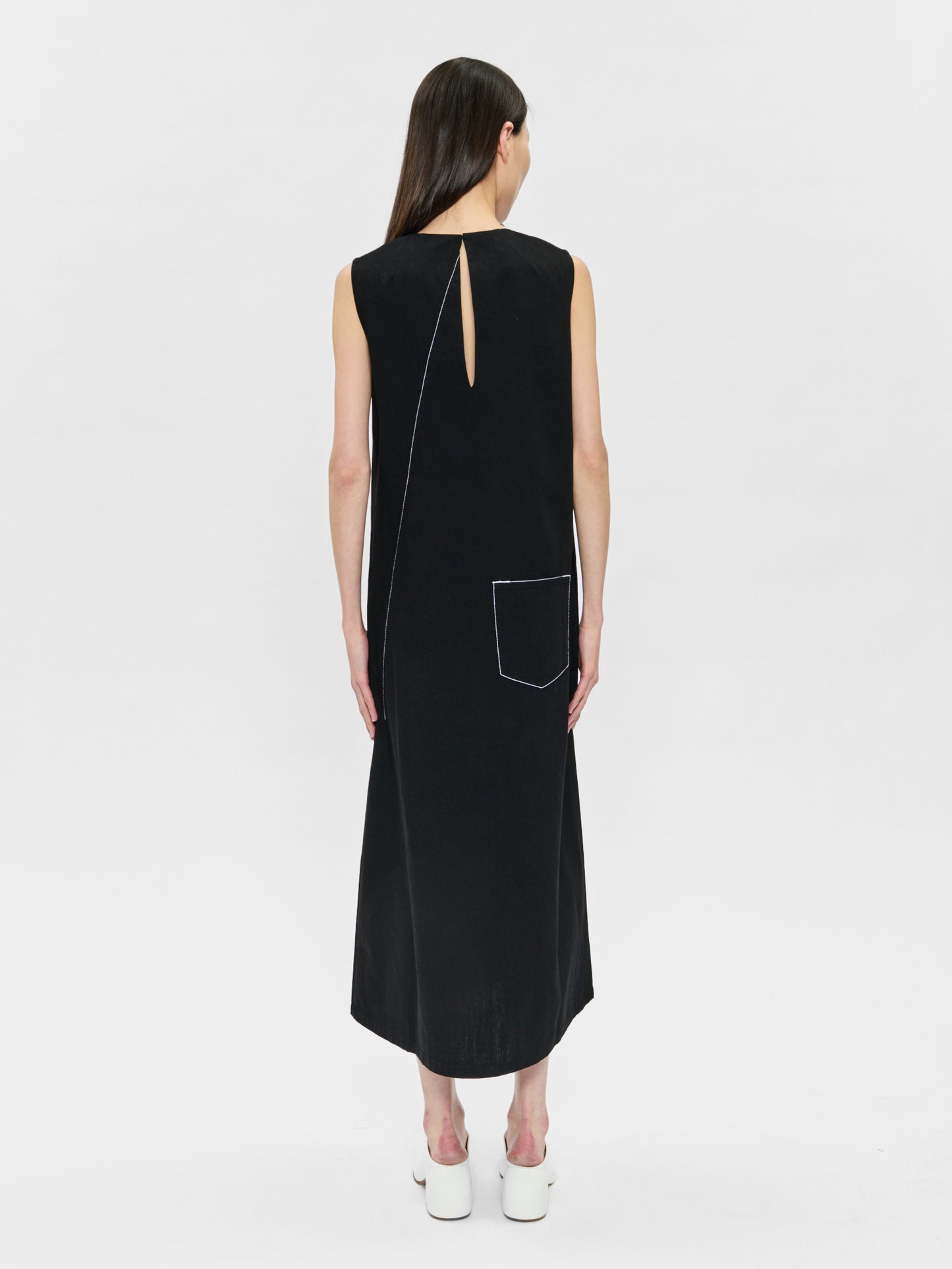 Black sleeveless dress with a unique back design on a white background