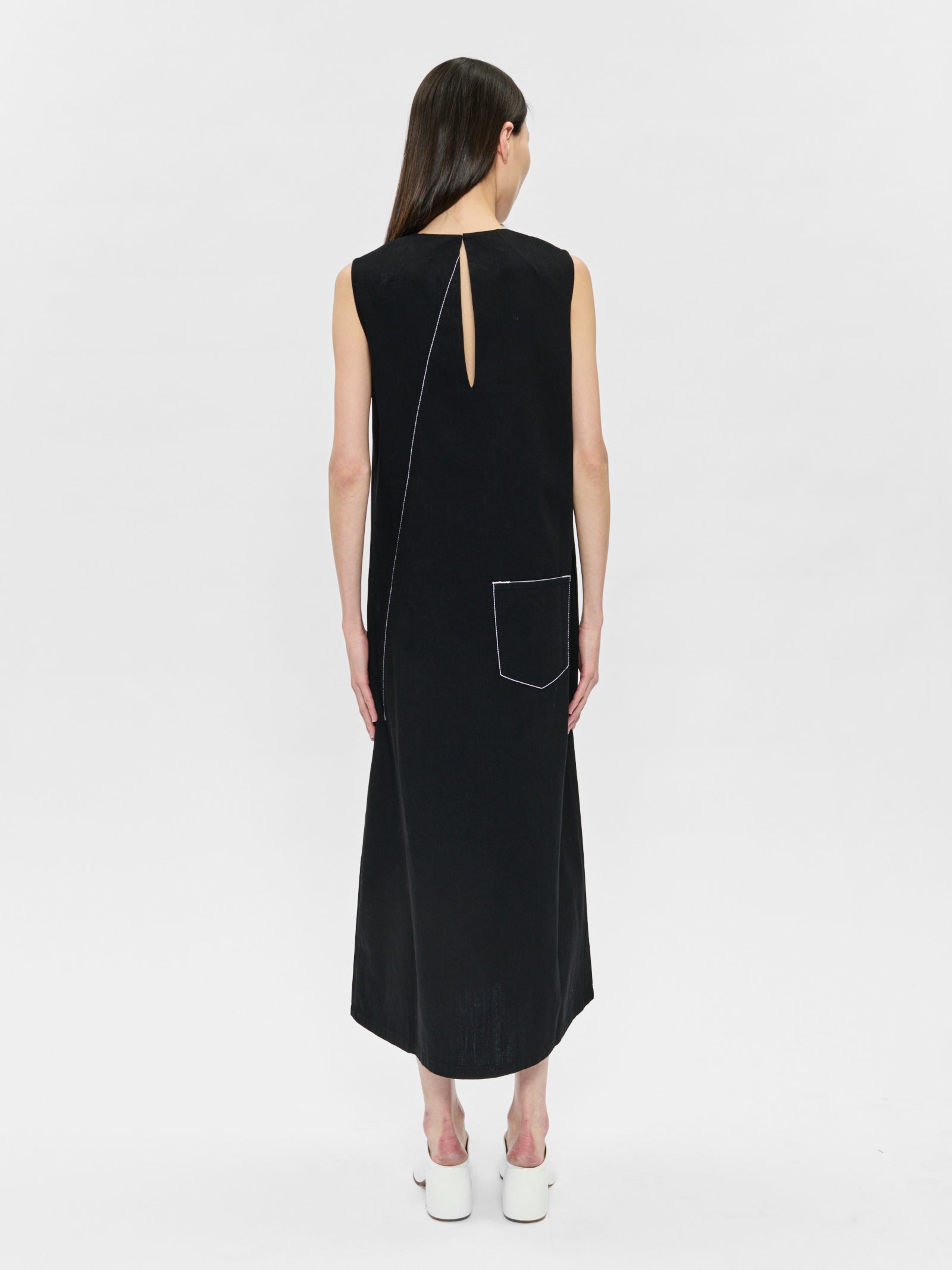 Black sleeveless dress with a unique back design on a white background