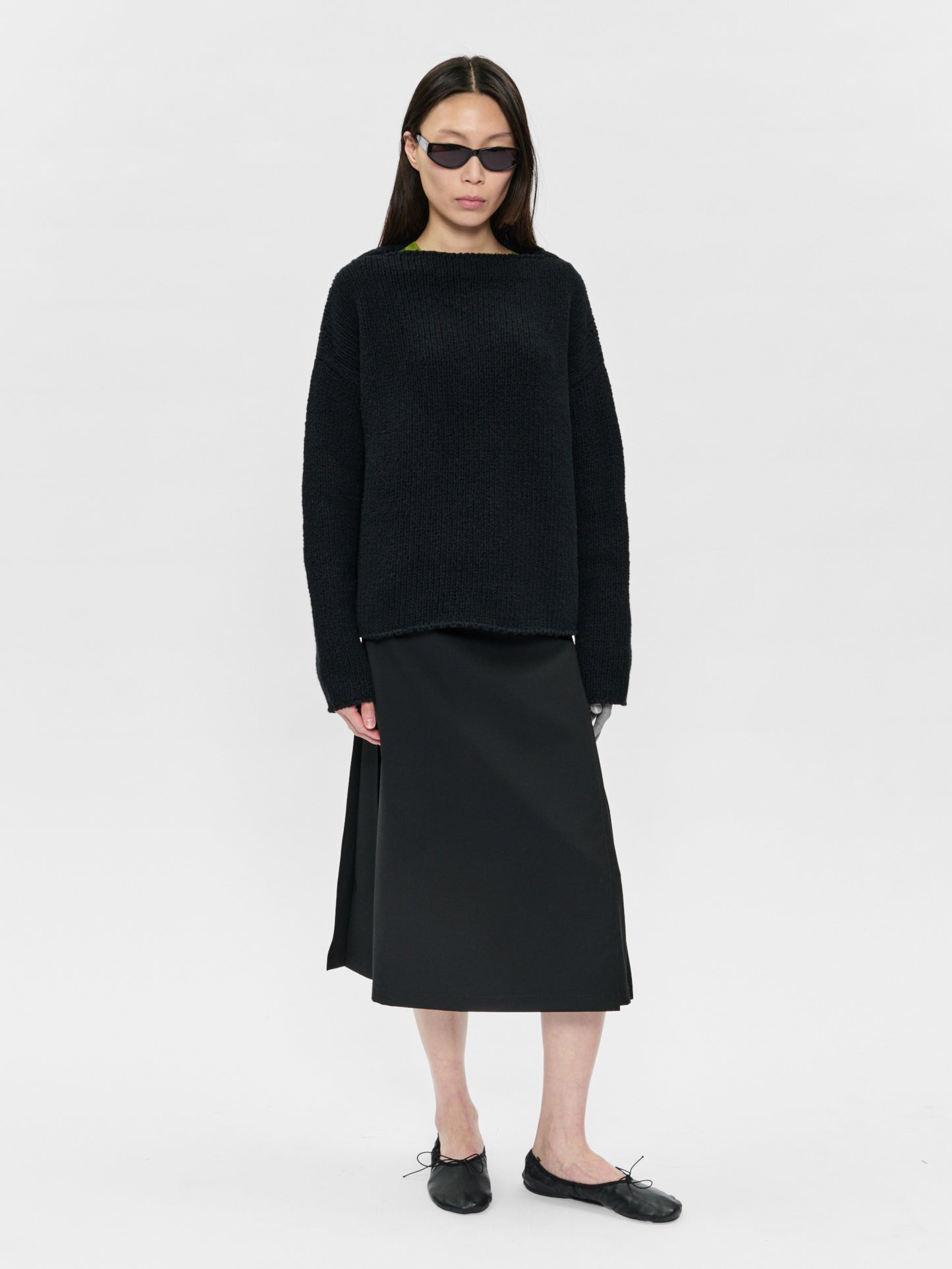 Person wearing a black outfit on a white background