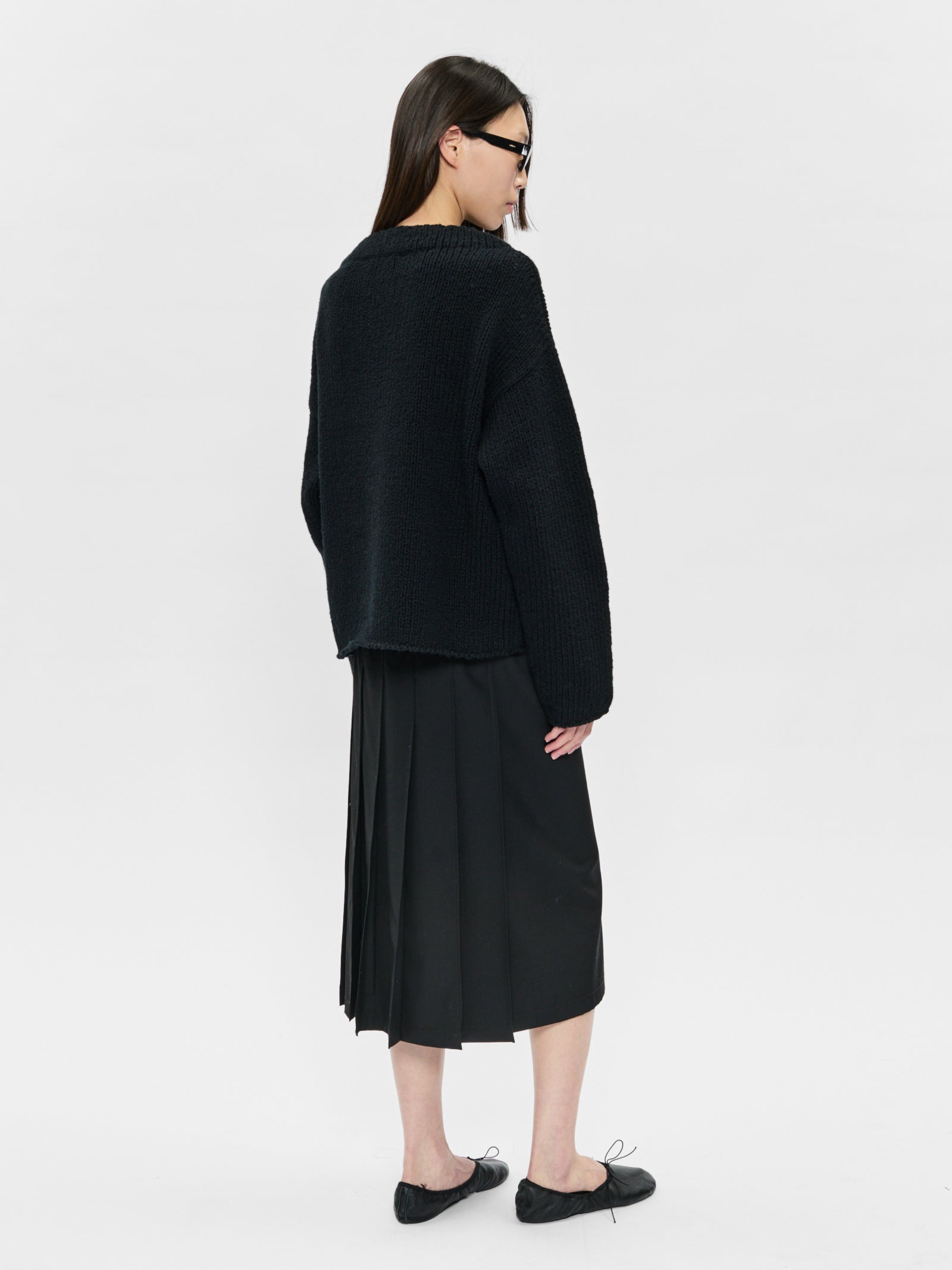 Person wearing a black outfit on a white background